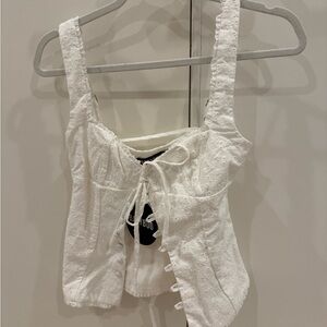 White sleeveless tank top with tie front and ruched details